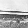 Packing shed with awnings and wagon on farmland