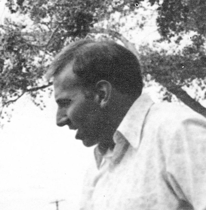 Profile view of white man in shirt talking outdoors
