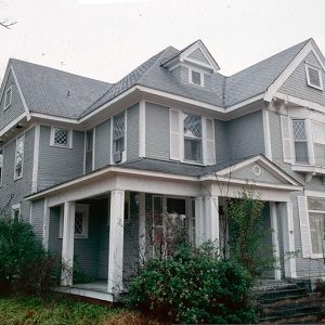 Multistory house with gray paint and corner porch