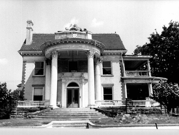 Multistory house with round front porch with columns