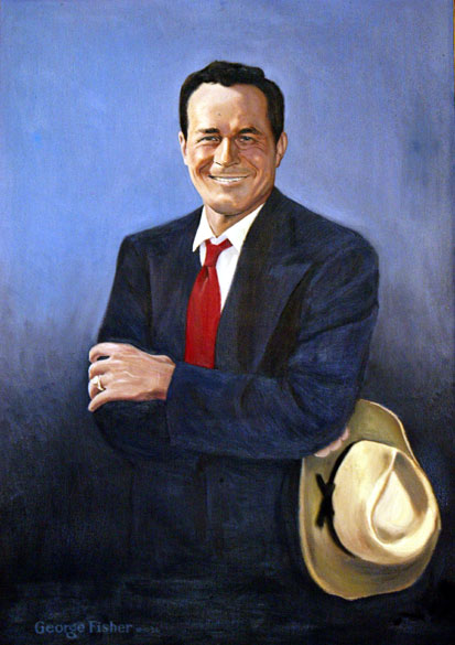 White man with crossed arms in suit with a cowboy hat in his left hand