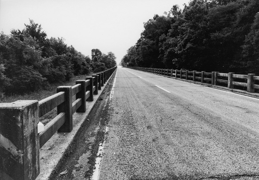 Concrete and asphalt highway bridge with railing