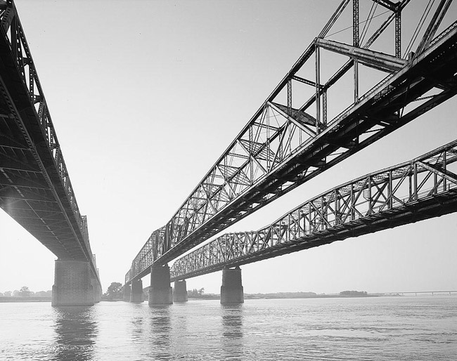 three steel bridges running parallel across a river