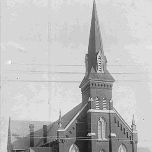 Brick church building with tall steeple