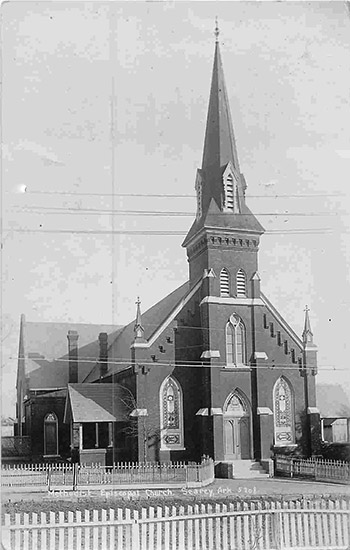 Brick church building with tall steeple
