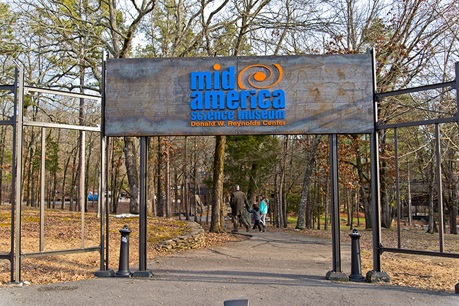 "Mid-America Science Museum" entrance sign over paved walking path