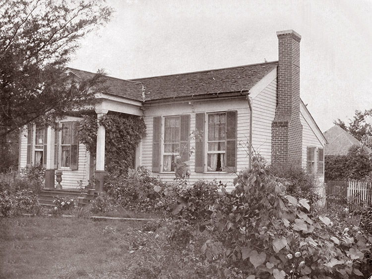 Single-story house with covered porch and brick chimney