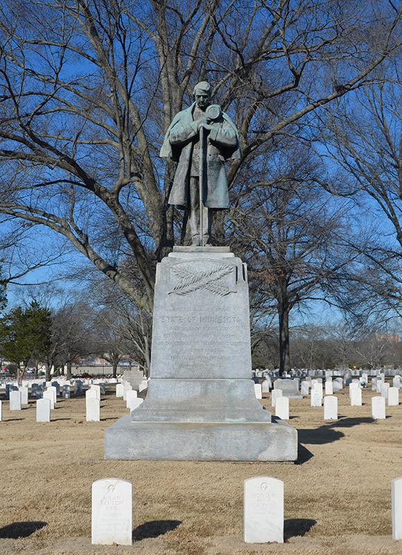 Statue of soldier standing on monument in cemetery
