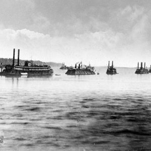 Steamboats and ironclad boat in river