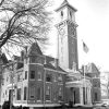 Brick courthouse with conical corner towers and tall bell tower