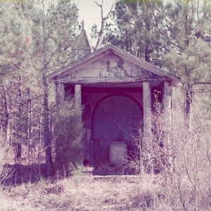 Abandoned chapel folly building in forested area
