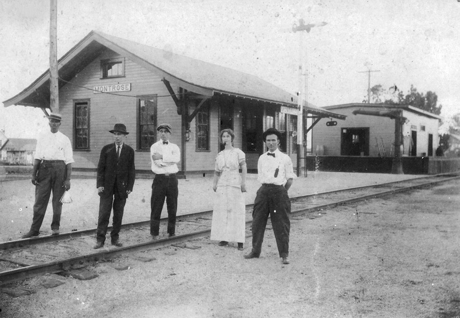 African-American man white men and woman at "Montrose" railroad depot