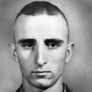 Nearly bald young white man in military uniform