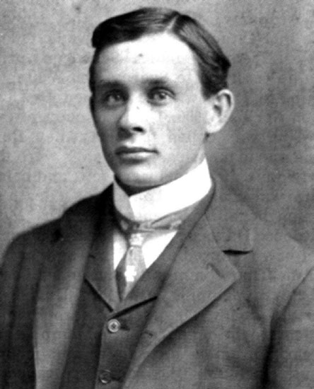 Young white man in suit and tie with white collar