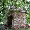 Ruins of stone brick smokehouse with roof