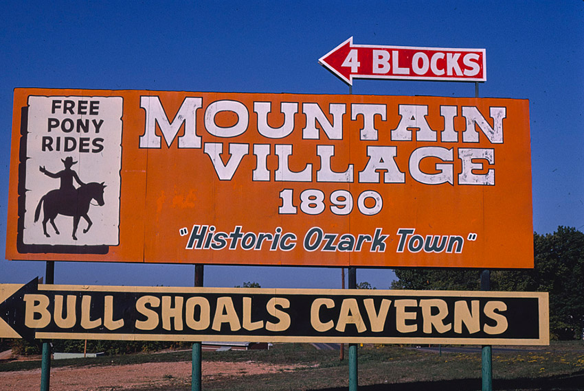 "Mountain Village 1890" and "Bull Shoals Caverns" billboards