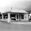 Service station building with covered drive-through on street corner