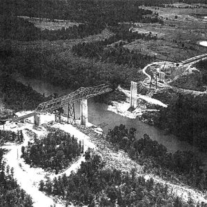 Aerial view of an unfinished steel truss bridge over a river