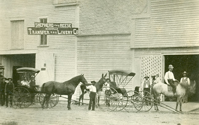 "Shepherd and Reese Transfer and Livery Co" building and men with horses men and horse drawn carriages