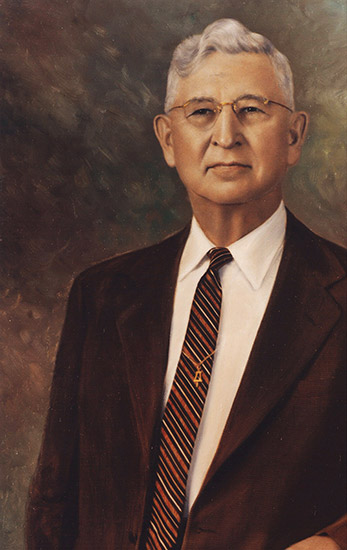 Older white man with glasses in suit and tie