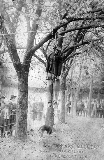 Postcard from "Bowen Art Gallery" in Newport depicting dead African-American suspended from noose in tree with white onlookers standing behind a fence