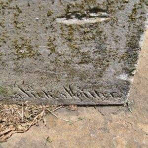 Close-up of engraved signature on gravestone