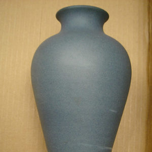 Blue vase with white swirls on its bottom section