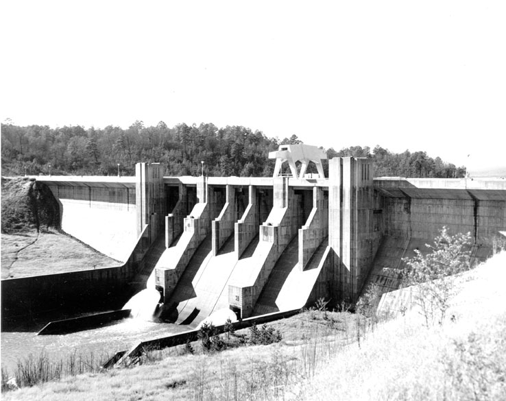 Concrete dam with trees in the background