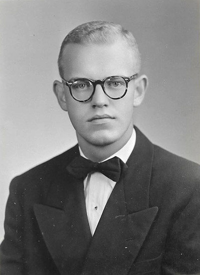 Young white man with glasses in suit and tie