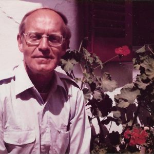 Older white man with glasses in collared shirt