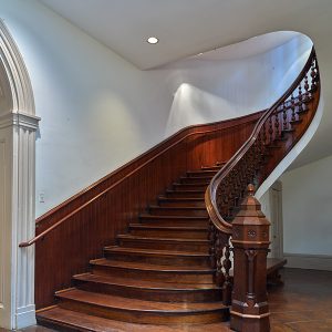 Wooden staircase with bannister and railing