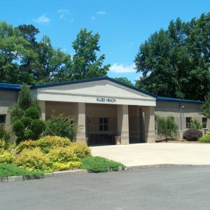 small light building with blue roof "Allied Health"