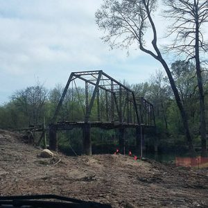 Steel truss bridge cleared grounds and river