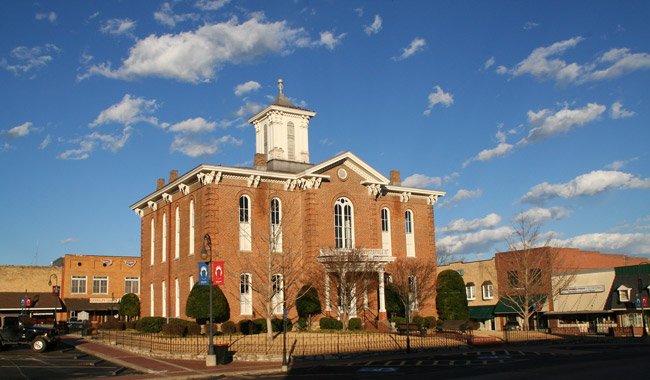 two story brick building with central tower
