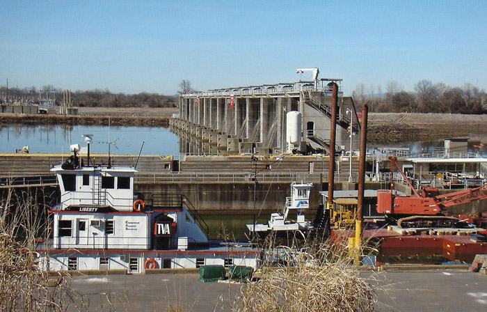 River with boat and machinery and concrete dam