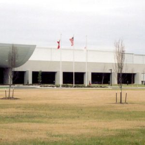 White building with three flags and "Denso" in red on the wall