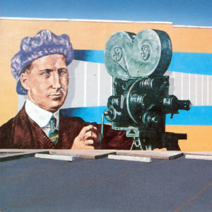 Mural of white man with a camera and another in a cowboy outfit