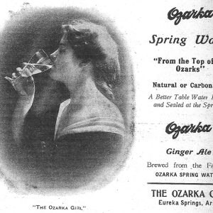 White woman drinking from a glass on advertisement