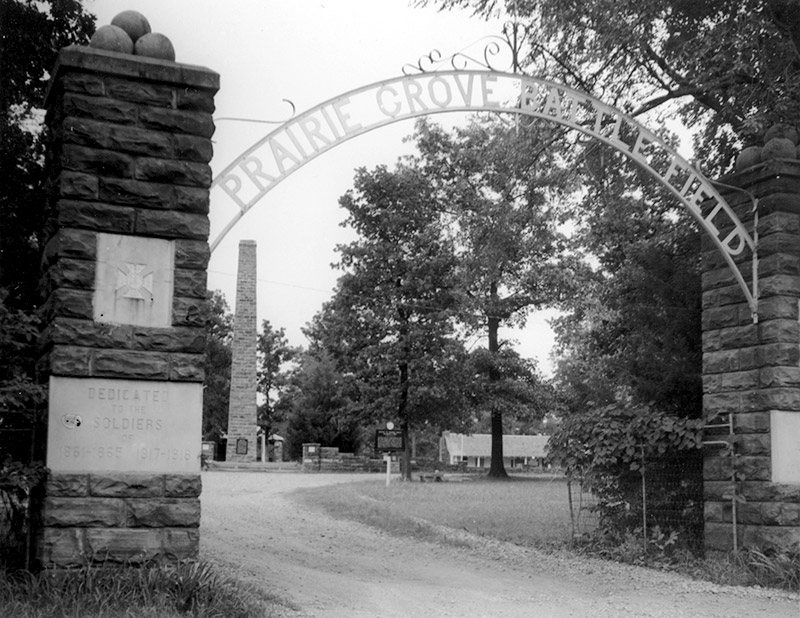 Entrance to park with iron arch over entrance "Prairie Grove Battlefield"