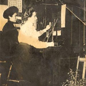 Two white women sitting at telephone switchboard