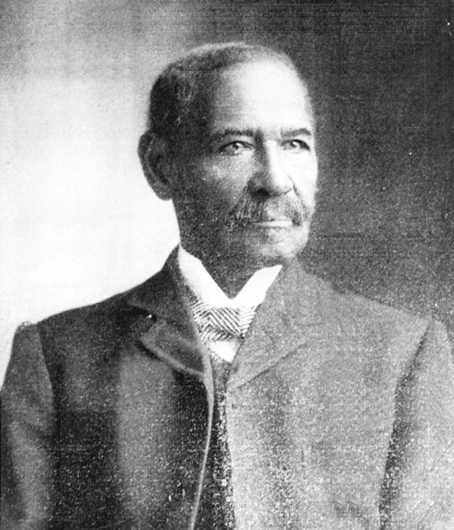 African-American man with a mustache in suit and tie