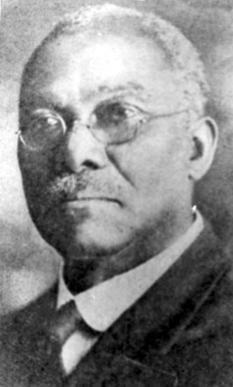 Older African-American man with mustache in suit and tie and glasses