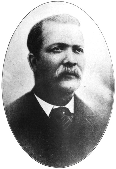 African-American man with a mustache in a suit and striped tie