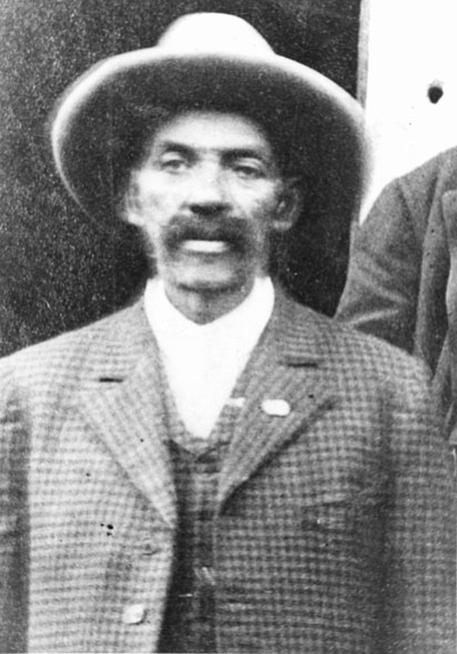 African-American man with thick wearing a hat in checkered suit