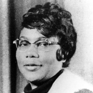 African-American woman with curly hair wearing glasses