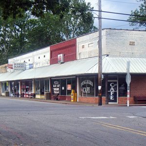 Brick storefronts on two-lane town intersection