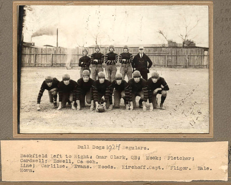 Group of young white men in matching uniforms with leather helmets in frame