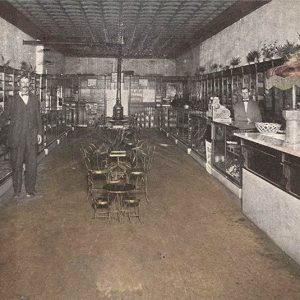Group of men inside store lined with cabinets