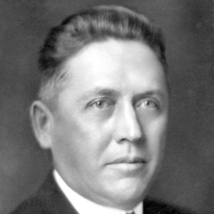 Middle-aged white man with white shirt in suit and tie