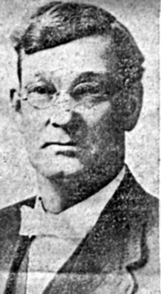 Old white man with glasses in suit and bow tie